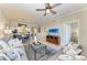 View of living room with dining area, kitchen, and TV at 7019 River Hammock Dr # 104, Bradenton, FL 34212