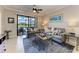 Living room featuring a large window overlooking the green backyard and water at 7019 River Hammock Dr # 104, Bradenton, FL 34212