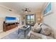 Comfortable living room with tile flooring and view to backyard at 7019 River Hammock Dr # 104, Bradenton, FL 34212