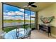 Relaxing screened lanai with comfortable seating and beautiful views of the golf course and lake at 7019 River Hammock Dr # 104, Bradenton, FL 34212