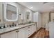 Elegant bathroom featuring double sinks, granite counters, and ample storage space at 7340 Golf Pointe Cir, Sarasota, FL 34243