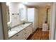 Elegant bathroom features double sinks, granite countertops, stylish cabinets and a glass enclosed shower for a luxurious feel at 7340 Golf Pointe Cir, Sarasota, FL 34243