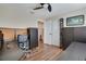 Bedroom area with wood floors, ceiling fan, workstation and a closet with ample storage at 7340 Golf Pointe Cir, Sarasota, FL 34243