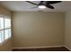 Neutral bedroom with fan, wood floors and shuttered window offers calming space at 7340 Golf Pointe Cir, Sarasota, FL 34243