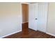 Well-lit bedroom featuring wood floors, closet, and doorway, creating a comfortable and inviting space at 7340 Golf Pointe Cir, Sarasota, FL 34243