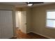 Bedroom with wood look floors, window with blinds, and closet at 7340 Golf Pointe Cir, Sarasota, FL 34243