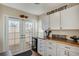 Dining area featuring a wine cooler, wine rack and access to the outdoor area at 7340 Golf Pointe Cir, Sarasota, FL 34243