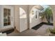 Charming front entryway with decorative sun, decorative concrete and door with window panes at 7340 Golf Pointe Cir, Sarasota, FL 34243