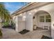 Front entrance with well-manicured landscaping, unique details and a covered entryway at 7340 Golf Pointe Cir, Sarasota, FL 34243