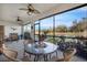 Lanai with ceiling fans, patio seating and a serene pond and golf course view at 7340 Golf Pointe Cir, Sarasota, FL 34243