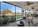 Lanai area with ceiling fans, comfortable seating and a scenic lake and golf view at 7340 Golf Pointe Cir, Sarasota, FL 34243