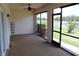 Enjoy tranquil water views from this spacious screened lanai with ceiling fan, perfect for outdoor living and relaxation at 7340 Golf Pointe Cir, Sarasota, FL 34243