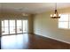 Bright living room with wood floors, ceiling fan, and sliding glass doors to the patio, offering a serene and inviting space at 7340 Golf Pointe Cir, Sarasota, FL 34243