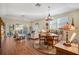 Living room featuring a dining area, hardwood floors, ceiling fan, and sliding glass doors at 7340 Golf Pointe Cir, Sarasota, FL 34243