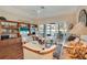 Living room with sliding glass doors leading to an outdoor living space overlooking a pond at 7340 Golf Pointe Cir, Sarasota, FL 34243