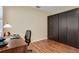 Home office featuring wood floors, ample storage with large cabinets, and natural light from the window for work and study at 7340 Golf Pointe Cir, Sarasota, FL 34243