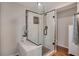 Elegant glass enclosed shower with decorative tile, seat and modern fixtures offer a spa-like experience in the bathroom at 7340 Golf Pointe Cir, Sarasota, FL 34243