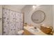 Bathroom with a vanity and shower/tub with a seashell patterned curtain at 7632 Plantation Cir, Bradenton, FL 34201