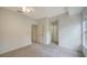 A well-lit, neutral bedroom features soft gray carpet and multiple doors for easy access at 7632 Plantation Cir, Bradenton, FL 34201