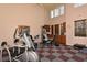 Bright community gym featuring modern exercise equipment, checkered floors, and natural light at 7632 Plantation Cir, Bradenton, FL 34201