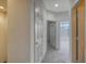 Hallway with neutral carpet and walls leading to other rooms of the house at 7632 Plantation Cir, Bradenton, FL 34201