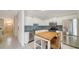 Well-lit kitchen features modern appliances, backsplash, and island with seating at 7632 Plantation Cir, Bradenton, FL 34201