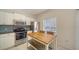 Bright kitchen with stainless steel appliances, white cabinets and a central island with seating at 7632 Plantation Cir, Bradenton, FL 34201