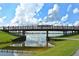 Picturesque bridge spanning a tranquil waterway in a park with lush greenery and a beautiful sky at 7632 Plantation Cir, Bradenton, FL 34201