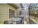 Cozy screened patio with a table, chairs, and views of the surrounding landscaping and trees at 7632 Plantation Cir, Bradenton, FL 34201