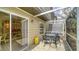Outdoor screened patio with patio furniture and view of the manicured garden at 7632 Plantation Cir, Bradenton, FL 34201