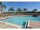 Community pool with lounge chairs and palm trees at 7632 Plantation Cir, Bradenton, FL 34201