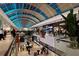 Vibrant interior of a shopping mall featuring diverse stores, lush greenery, and a unique architectural design at 7632 Plantation Cir, Bradenton, FL 34201