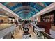 Bright indoor shopping mall with stores and restaurants on multiple levels and a unique arched glass ceiling at 7632 Plantation Cir, Bradenton, FL 34201