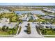 Community aerial view highlighting a pool, clubhouse, sports courts, lake, and lush landscaping at 8271 Redonda Loop, Lakewood Ranch, FL 34202