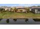 Aerial view of backyard featuring pool, landscaping and peaceful lake at 8271 Redonda Loop, Lakewood Ranch, FL 34202
