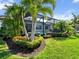 Beautiful backyard featuring a swimming pool, screened lanai, and lush tropical landscaping at 8271 Redonda Loop, Lakewood Ranch, FL 34202