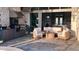 Outdoor living space featuring an outdoor kitchen, rattan furniture set, and travertine paver flooring at 8271 Redonda Loop, Lakewood Ranch, FL 34202
