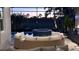 Outdoor living space featuring a built-in kitchen, and comfortable seating area with water view at 8271 Redonda Loop, Lakewood Ranch, FL 34202