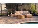 Outdoor living space with rattan furniture, a small round table, and lush landscaping at 8271 Redonda Loop, Lakewood Ranch, FL 34202
