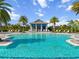 Beautiful community pool area surrounded by palm trees and a charming pool house at 8271 Redonda Loop, Lakewood Ranch, FL 34202