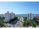 Street view features palm trees, waterfront condos and townhouses with a view of the bay in the background at 1111 N Gulfstream Ave # 8D, Sarasota, FL 34236