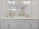 Clean bathroom featuring dual sinks, a large mirror, and a separate shower room for a spa-like experience at 11419 Gallatin Trl, Parrish, FL 34219