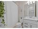 Bright bathroom featuring a shower with white curtain, white toilet and vanity at 11419 Gallatin Trl, Parrish, FL 34219