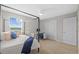 Bright bedroom with ceiling fan features four-poster bed, desk, and windows with a view at 11419 Gallatin Trl, Parrish, FL 34219