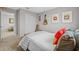 Well-lit bedroom features a queen-sized bed, guitars on the wall, and view into an adjacent room at 11419 Gallatin Trl, Parrish, FL 34219