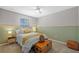 Comfortable bedroom with green walls, a cozy bed, and side tables, creating a relaxing and inviting atmosphere at 11419 Gallatin Trl, Parrish, FL 34219