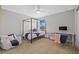 Bright bedroom features four-poster bed, desk, night stand, and a comfortable chair at 11419 Gallatin Trl, Parrish, FL 34219