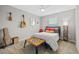 Bright bedroom features a guitar, wall art, and a comfortable bed with colorful pillows at 11419 Gallatin Trl, Parrish, FL 34219