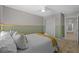Cozy bedroom features neutral tones, a ceiling fan, and a closet with sliding doors for a minimalist aesthetic at 11419 Gallatin Trl, Parrish, FL 34219