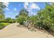 Charming bicycle rack area with bikes, surrounded by lush greenery, flowering bushes and a paved path for easy access at 11419 Gallatin Trl, Parrish, FL 34219